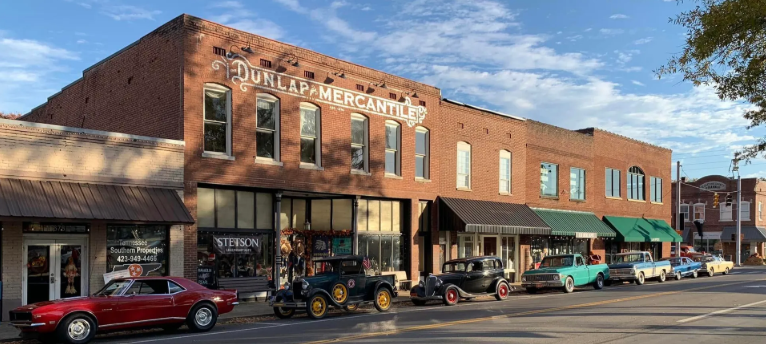 Historic Dunlap Mercantile building on Main Street in Dunlap, Tennessee with classic cars